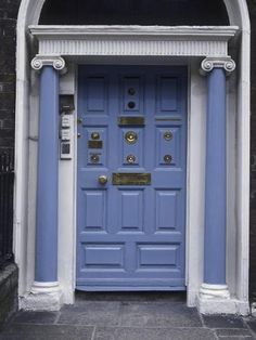 a blue front door with columns and a phone