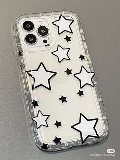 an iphone case with black and white stars on the back, sitting on a table