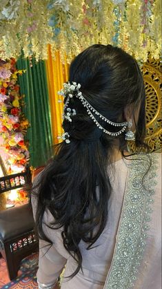 a woman with long black hair wearing a white sari