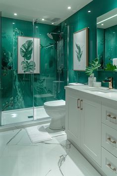 a bathroom with green walls and white counter tops, two sinks, toilet and walk in shower