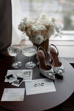 a table topped with wine glasses and pictures