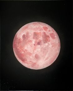 a pink moon is shown against a black background