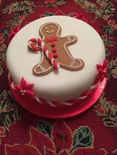 a decorated gingerbread cake sitting on top of a table