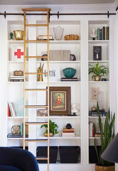 a living room filled with furniture and shelves