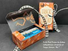 an orange and black box with some kind of trick or treat in it on a table