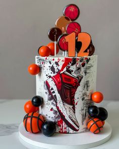 a birthday cake decorated with basketballs and balls