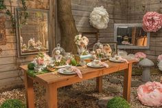 a wooden table topped with plates covered in flowers