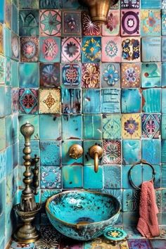 a bathroom with blue and green tiles on the wall, sink and mirror in it