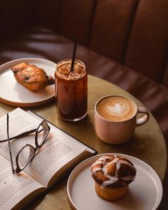 an open book and cup of coffee on a table