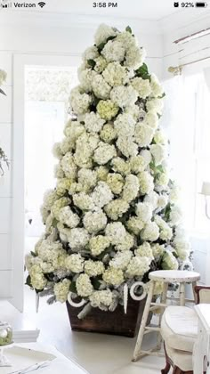 a white christmas tree in the corner of a room