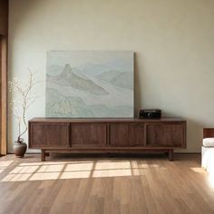 a living room with a large painting on the wall