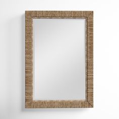 a square mirror hanging on the wall