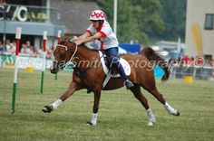 a woman riding on the back of a brown horse