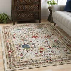 a living room with a white couch and rug