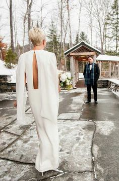 two people standing in front of a gazebo with snow on the ground