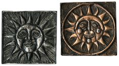 two metal sun and moon wall plaques, one in bronze and the other in black