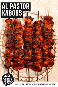 several skewers of food on a plate with the words, al pastor kabobs