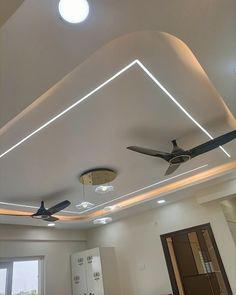 an empty room with ceiling fans and lights