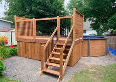 a wooden deck with steps leading up to an above ground pool