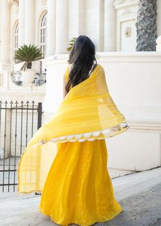 This showstopper mango yellow, Devi, is a must have for your mehendi/haldi ceremony! This colorful and playful mirror lehenga is the perfect party piece. Blouse, skirt, and dupatta included. Summer Wedding Sharara With Gota Work, Yellow Traditional Wear With Mirror Work For Festive Occasions, Festive Yellow Traditional Wear With Mirror Work, Festive Traditional Yellow Wear With Mirror Work, Yellow Mirror Work Traditional Wear For Festive, Yellow Floor-length Dupatta, Summer Party Dress With Gota Work, Yellow Gota Work Sharara For Festivals, Yellow Anarkali Set With Mirror Work