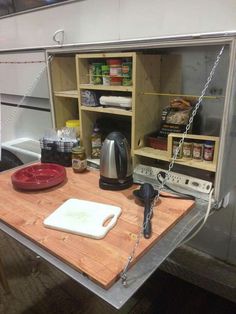 a kitchen area with a cutting board on the counter