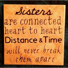 a sign that says sisters are connected heart to heart distance and time will never break them apart