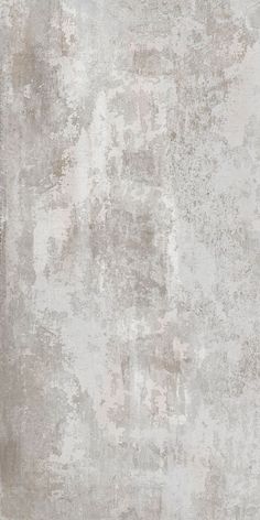 an old, dirty wall is shown in grey and white colors with some stains on it