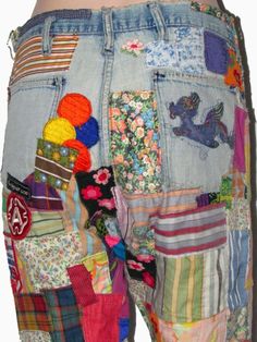 the back of a person's jeans with patches on them and buttons in the pockets