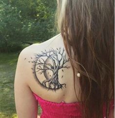 a woman with a tree tattoo on her back