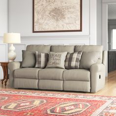 a living room scene with focus on the couch and rug in front of the sofa