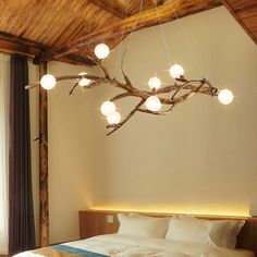 a bedroom with a bed and lights hanging from the ceiling