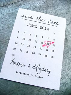 a wedding save the date card with a heart on it