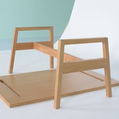 two wooden chairs sitting next to each other