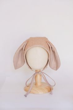 Welcome the joys of Easter with our enchanting Handmade Easter Bunny Bonnet! Crafted with love and attention to detail, this adorable bonnet will have your little bunny hopping with excitement. Featuring delightful bunny ears, this bonnet adds a whimsical touch to any Easter ensemble. Whether it's for an Easter egg hunt, a festive photo shoot, or a springtime stroll, your little one will steal the spotlight in this precious accessory. Not just for Easter, this bonnet is versatile enough to be worn throughout the spring season, adding a dash of cuteness to everyday outfits. It also makes a thoughtful gift for baby showers or birthdays, sure to be cherished for years to come. Make this Easter memorable with our Handmade Bunny Bonnet - a treasured keepsake that captures the essence of springt Cute Adjustable Cream Bonnet, Cute Fitted Hats For Playtime, Adjustable Cream Bonnet As A Gift, Adjustable Cream Bonnet As Gift, Cute Adjustable Bonnet As Gift, Bunny Hopping, Bunny Bonnet, Handmade Bunny, Easter Bonnet