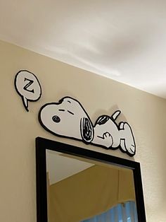 there is a mirror with a cartoon dog on it