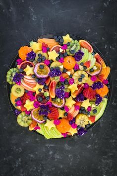 a black plate topped with lots of fruit