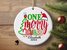 one merry christmas ornament hanging on a wooden wall with ornaments around it and a tree in the background