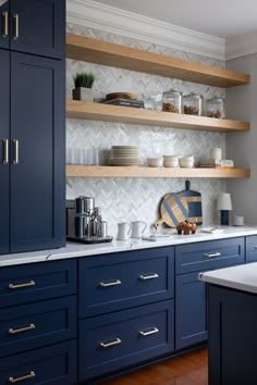 The scullery kitchen features smart storage solutions that keep everything organized and within reach.  Photography || Christy Kosnic Photography  #SculleryKitchen #SculleryKitchenDesign #Scullery #2NL #Design  #TwoNavyLane  #RenovationSpecialists #NewBuilds #NewBuildHouse #NewBuildHomes #InteriorArchitecture #ElleDecor #VogueLiving #HouseBeautiful #PrettyLittleInteriors #ResidentailInteriorDesign #LivableLuxury #InteriorDesignersofInstagram #LuxuryInteriorDesign #LuxuryInteriors #LuxeAtHome Modern Scullery, White Kitchen Cabinets With Butcher Block, Blue And White Kitchen Cabinets, Scullery Kitchen, Navy Cabinets, Family Room Remodel, Kitchen Light Fixtures, Quick Breakfasts, Navy Design