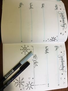 two notebooks with christmas writing on them and a pen next to one that has snowflakes