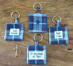 four blue and white plaid flannel key fobs hanging from metal hooks