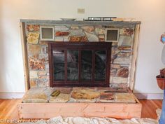 a man standing in front of a stone fireplace