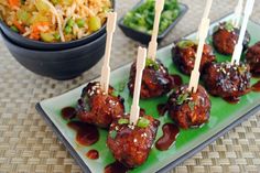 some meatballs are sitting on a plate with toothpicks sticking out of them