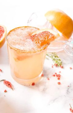 a grapefruit cocktail garnished with an orange slice