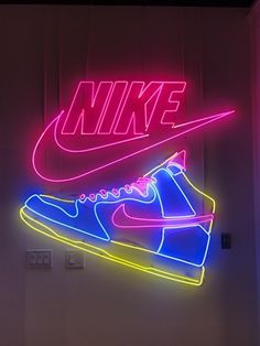 a neon nike shoe is displayed on the wall