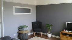 a living room filled with furniture and a flat screen tv on top of a wooden stand