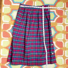 Vintage 1980s cotton plaid skirt by David Brooks. Red, green, yellow, blue and black plaid heavy weight cotton, pleated with a full button side. One on seam pocket. Made in USA. Material / cotton Care / machine wash Please compare measurements to a garment that fits you well for accurate fit. Make allowance for clothes underneath and room to allow garment to drape properly when worn. Mannequin measures 35" - 24" - 34", skirt is clipped on mannequin for proper fit. Size on tag / 14 (fit is closer Vintage Plaid Cotton Skirt, Retro Plaid Cotton Skirt, David Brooks, Green Yellow Blue, Red Green Yellow, Plaid Skirt, Plaid Skirts, 1980s Vintage, Vintage Cotton