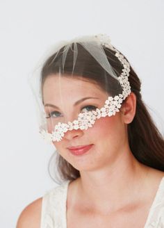 a woman wearing a veil with flowers on it