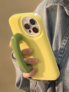 a person holding a yellow case with a banana on it and a phone in the other hand