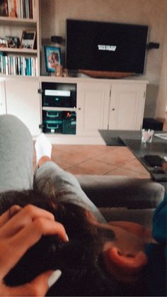 a person laying on the couch with their feet up