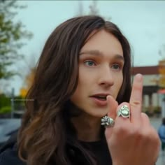 a woman making the peace sign with her fingers